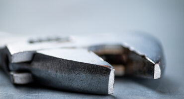 Metal wrench on the table. On a gray background. High quality photo